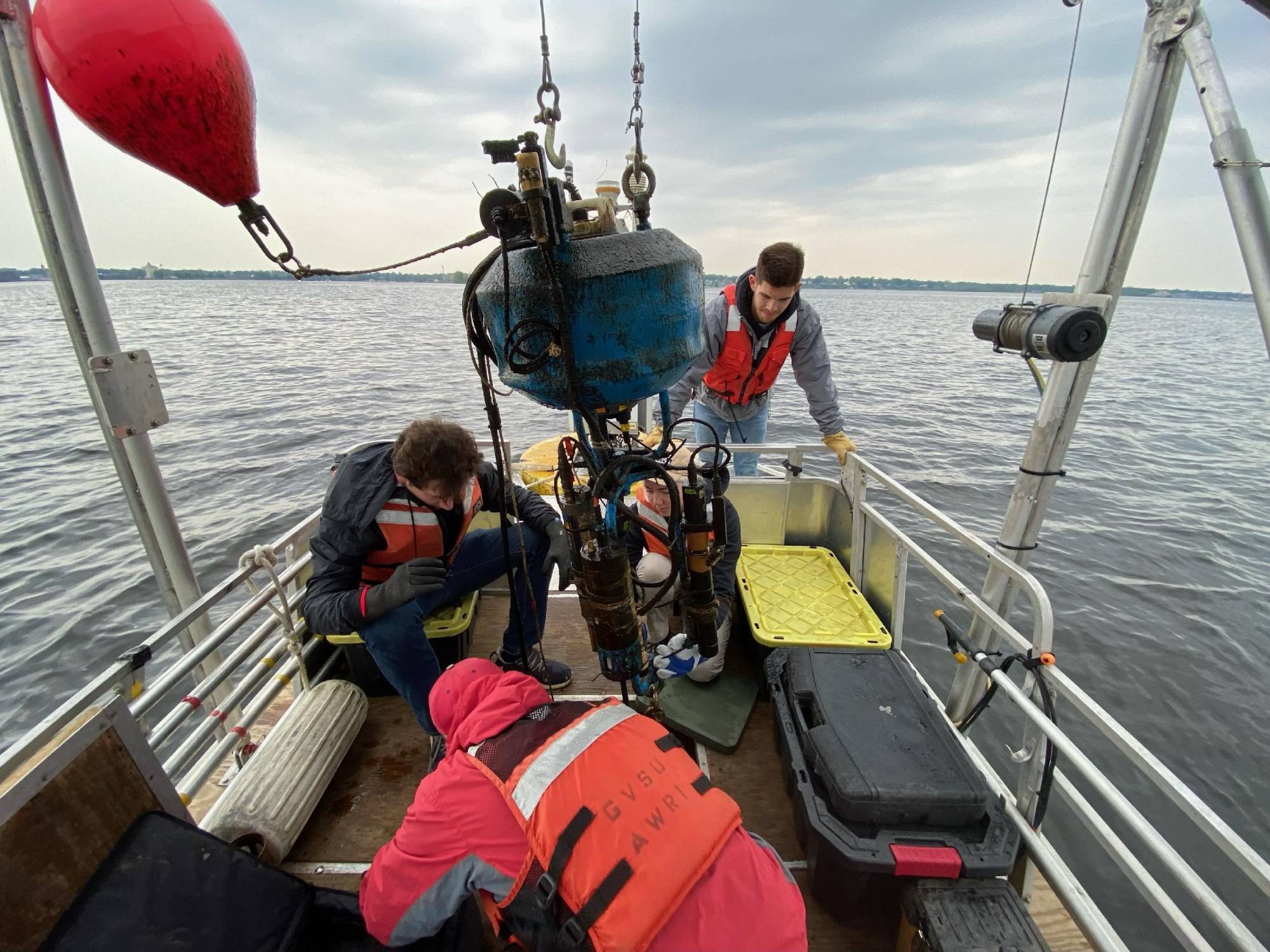 Students and researcher Dr. Bopi Biddanda aboard a Pontoon boat on Muskegon Lake.